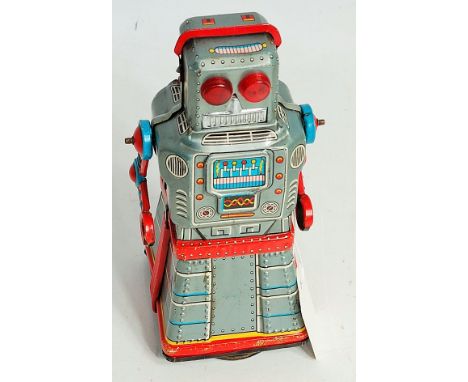 A KO Yoshiya tinplate and friction drive Atom robot with skirted legs, comprising of silver body, with red, blue and yellow d
