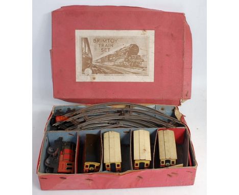 An early Brimtoy tinplate and clockwork passenger coach train set comprising of locomotive and tender and four coaches (one c