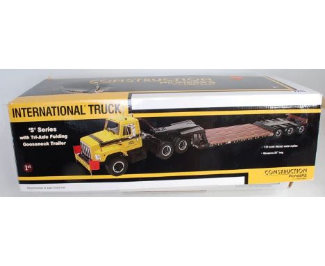 Construction Pioneers manufactured by First Gear S Series International truck with tri-axle folding goose-neck trailer, 1/25 