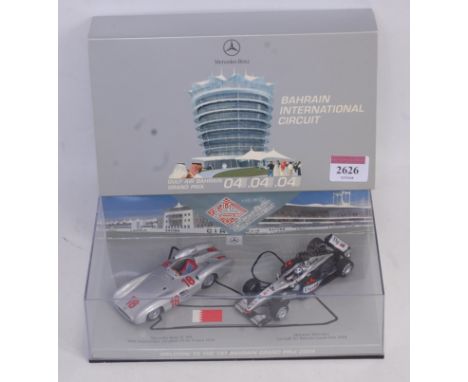 A Minichamps 1/43 scale model Mercedes Benz W196/Maclaren Formula One Bahrain Grand Prix 2004 box set, limited edition exampl