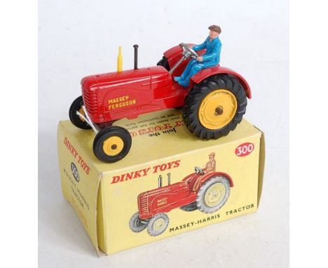 A Dinky Toys No.300 Massey Harris tractor, comprising red body with yellow hubs (rear cast, the front are plastic), with blue