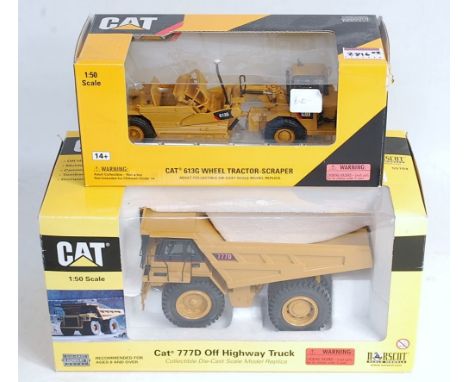 A Cat 777D off-highway truck, 1/50 scale diecast model, in window box; and a Cat 613G wheel tractor-scraper, 1.50 scale, in w