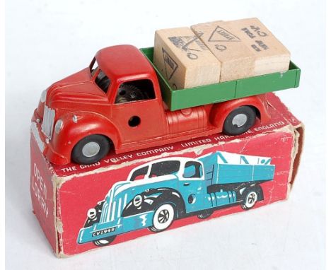 A Chad Valley No.225 open lorry, comprising red body with green back and silver hubs, with three wooden crates, in the origin