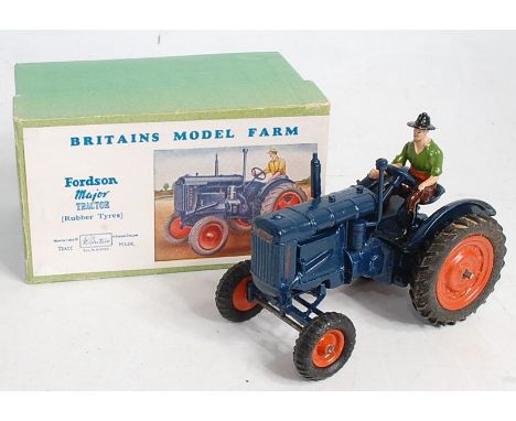 A Britains No. 128F Fordson Major tractor with driver, comprising dark blue body with orange hubs and driver figurine, in the