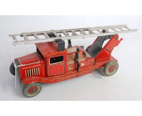 A 1930s Wells tinplate fire engine with clockwork action and Dunlop 90 wheels and with attendant fire officers