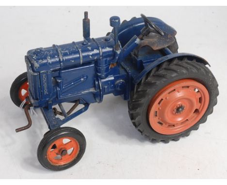 A Chad Valley clockwork large scale Fordson Major tractor, comprising dark blue body with orange hubs, rear linkage with Chad