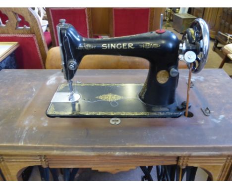 A vintage Singer sewing machine on a Jones treadle base.