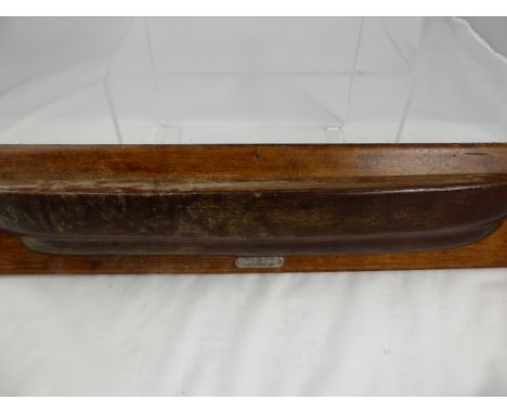 A wall mounted item in the form of a ship's hull, the teak being from HMS Champion, built by Nathaniel Barnaby, launched in 1