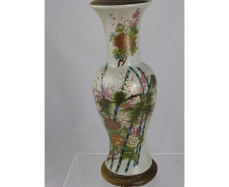 Three table lamps - one being ceramic with oriental floral decoration, another being pottery and the other being alabaster in