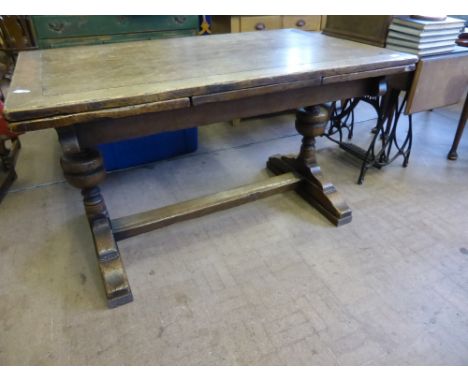 A Vintage Oak Drawer Leaf Dining Table, supported on bulbous columns on splayed feet with single stretcher, est 227 cms (exte