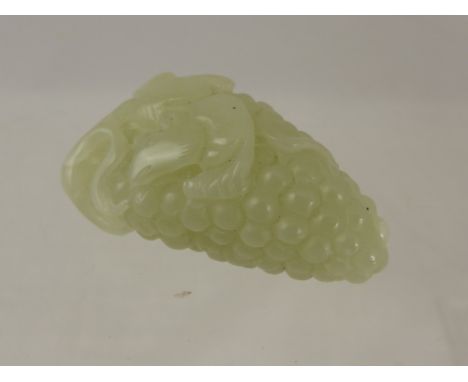 A Chinese Celadon Jade carving of a mouse on a bunch of grapes. 