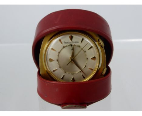 A Jaeger Le Coutre vintage travel alarm clock, bevel number to reverse 828328, in the original red leather travelling case.