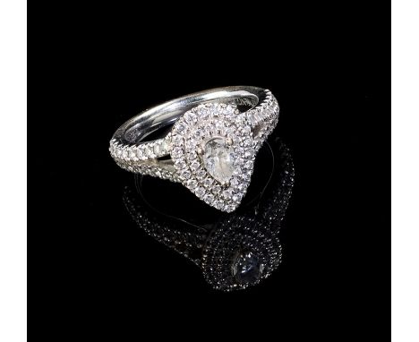 A diamond cluster ring, the pear-shaped principal diamond within a double row of brilliant cut diamonds to bifurcated diamond