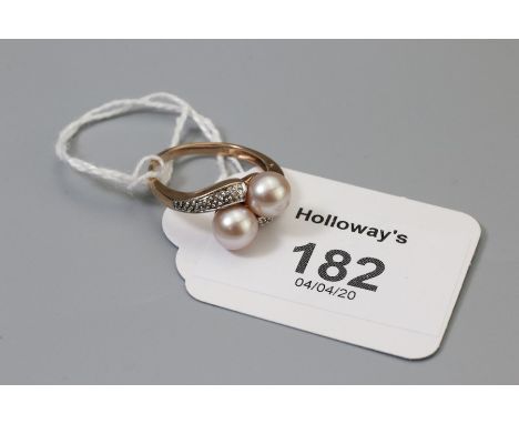 A cultured pearl and diamond cross-over ring, the graduated diamond set shoulders with single stone cultured pearl terminals,