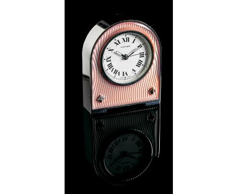 Cartier, a dressing table alarm clock, arched shape with circular dial and Roman numerals, engine turned to front with colour