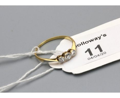 A three stone diamond half hoop ring, the old brilliant cut diamonds in collet-set millegrain mounts to plain shank marked '1