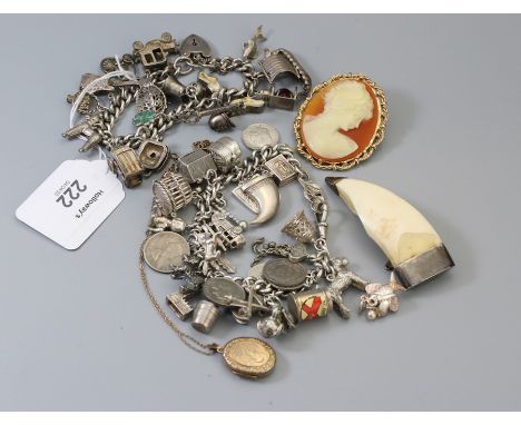 A substantial silver charm bracelet, suspending numerous charms, another similar, a 9ct gold locket and a three items of othe