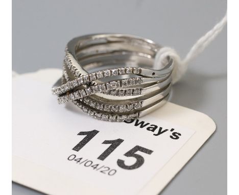 A four row diamond set crossover ring, each row set with single cut diamonds, to a crossover centre, marked '750',  Ring size