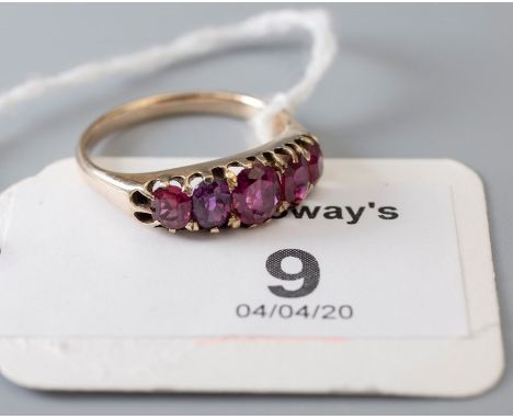 A five stone half hoop ruby ring, the graduated oval cut rubies in claw mounts to plain shank 3.1g, Ring Size O