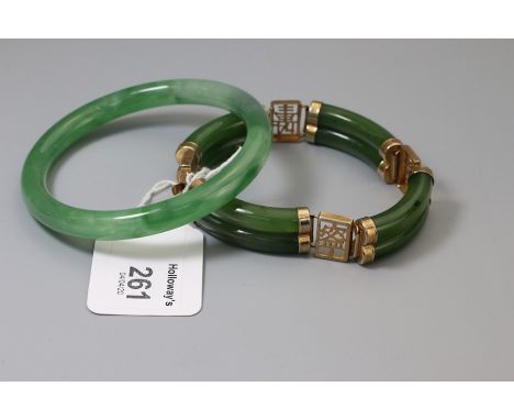 A jade bangle, and another with curved panels and rectangular sapphires with oriental script