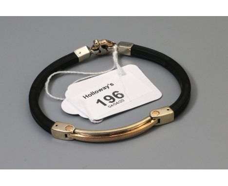 Baraka, a bi-coloured gold and rubber bracelet, with curved bio-coloured hinged panel to centre, diamond set clasp signed Bar