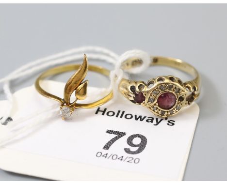 A ruby and diamond cluster ring,with ruby set shoulders in 18ct gold mount (one ruby deficient) together with a single clear 