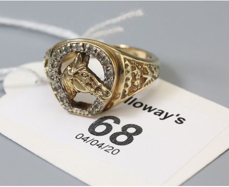 A diamond set horseshoe ring, with horse head to centre,k 9ct gold engraved shoulder and shank, Ring size Q, 5.9g