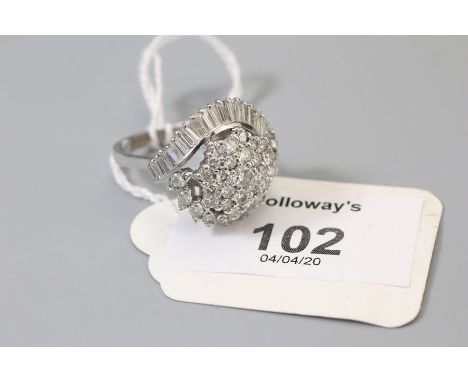 A diamond cluster ring, the central brilliant cut diamond cluster with a frame of brilliant cut and baguette cut diamonds,  R