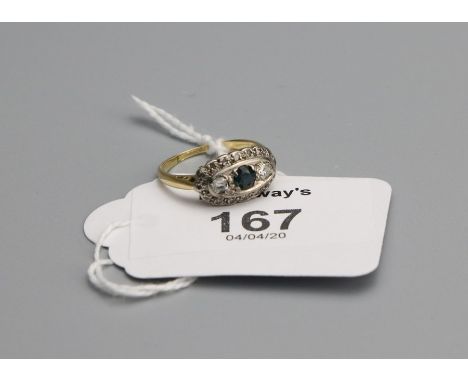 An Edwardian three stone half hoop sapphire and diamond ring, the circular cut sapphire cushion shaped diamonds within a diam