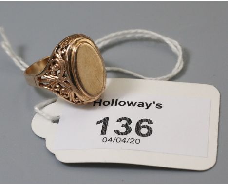 An Eastern European signet ring, the vacant oval plaque above scroll pierced shoulders and plain shank stamped '585', 5.3g, s