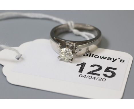 A single stone diamond ring, the mixed old brilliant cut diamond in raised four claw mount, to tapering shoulders marked '585