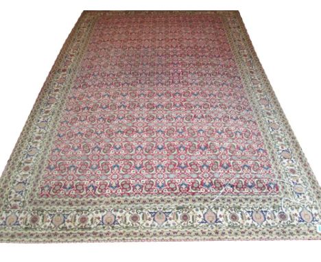 ANTIQUE ANATOLIAN CARPET, 400cm x 273cm, all over design of scrolling vines and palmettes on cerise field within ivory border