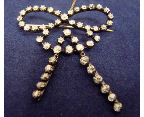 A late 19th/early 20th century diamond set bow brooch in white metal with a yellow metal pin, set with fifty old brilliant cu