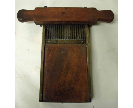 A 19th century mahogany and brass mounted pill roller with double handle pill roller and integrated tray 15.5cm by 34cm