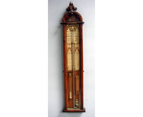 An Admiral Fitzroy forecasting barometer of typical form in a Gothic style arch top light oak case with carved pediment and c