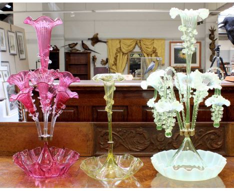 A Green Glass Epergne, with central stem and three further stems interspersed with canes and baskets, 60cm high, together wit