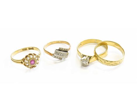 Four Rings, comprising of an 18 carat gold band ring, finger size N1/2; a diamond three stone twist ring, stamped '18', finge