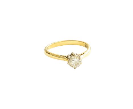 An 18 Carat Gold Diamond Solitaire Ring, the round brilliant cut diamond in a white claw setting, to a yellow tapered shoulde