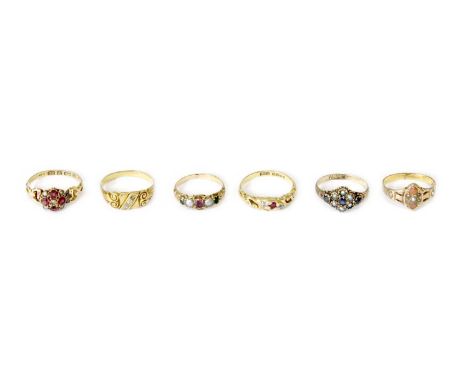 Six Rings, comprising of an 18 carat gold ruby and diamond three stone ring, finger size L1/2; a pink/red stone and split pea