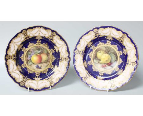 A Pair of Royal Worcester Fruit Painted Parcel-Gilt Plates, both signed R. Sebright, on cobalt blue grounds, both restored, 2