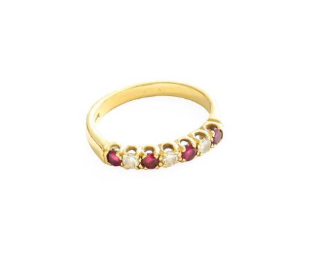 An 18 Carat Gold Ruby and Diamond Half Hoop Ring, four round cut rubies spaced by three round brilliant cut diamonds, in yell