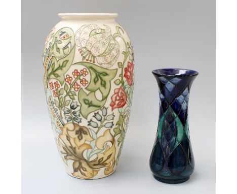 Two Modern Moorcroft Vases, one decorated with stylised flowers on a cream ground, 32cm high, the other on a blue ground 21cm