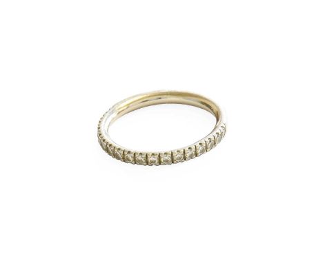 A Platinum Diamond Half Hoop Ring, the round brilliant cut diamonds in claw settings, to a plain polished shank, finger size 