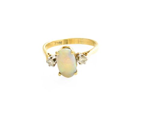 An Opal and Diamond Three Stone Ring, the oval cabochon opal in a yellow claw setting, flanked by round brilliant cut diamond