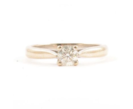 A diamond solitaire ring, the brilliant cut stone four claw set in an 18 carat all white gold mount ring size I½, Birmingham,