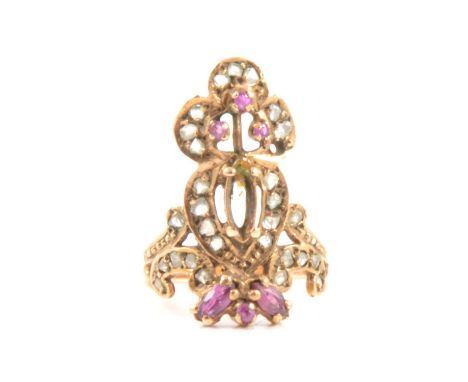 An Indian style ruby and diamond ring, the heart and coronet design set with six rubies and rose cut diamonds in a yellow met