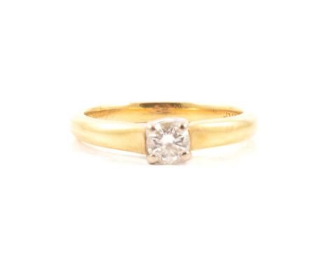 A diamond solitaire ring, the brilliant cut stone claw set in an 18 carat yellow and white gold mount ring size M, approximat