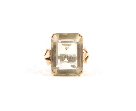 A pale citrine dress ring, the rectangular emerald cut stone, 20x15mm, claw set in an all yellow metal mount ring size adapte