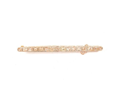 A diamond bar brooch, the sixteen graduated old cut diamonds pip claw set in a yellow and white metal milgrain edge bar mount