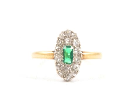 A diamond cluster ring with synthetic green stone, sixteen old cut diamonds surrounding a rectangular green stone in a yellow